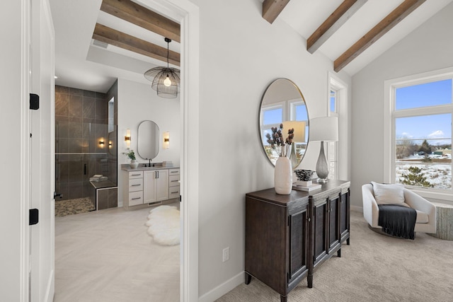 hall featuring beam ceiling, high vaulted ceiling, and baseboards