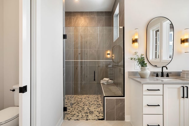 full bathroom with vanity, toilet, a stall shower, and tile patterned flooring