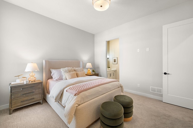 bedroom with visible vents, light colored carpet, connected bathroom, and baseboards