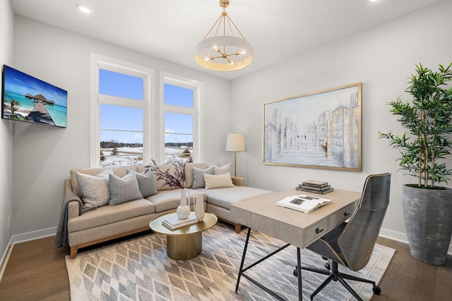 office space with an inviting chandelier, recessed lighting, wood finished floors, and baseboards