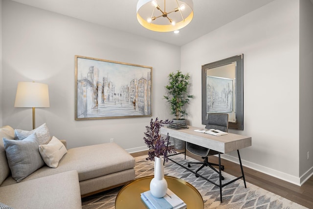 office space with recessed lighting, a chandelier, baseboards, and wood finished floors