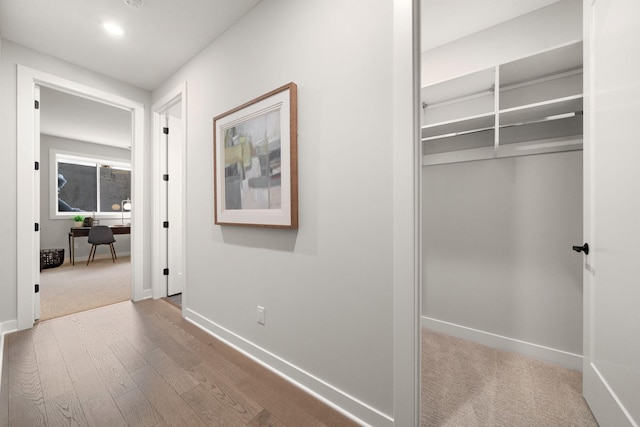 hallway with carpet flooring, recessed lighting, baseboards, and wood finished floors