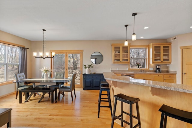 dining space with visible vents, baseboards, recessed lighting, light wood-style flooring, and a notable chandelier