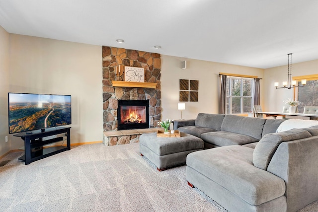 living room with a notable chandelier, carpet flooring, a fireplace, and baseboards