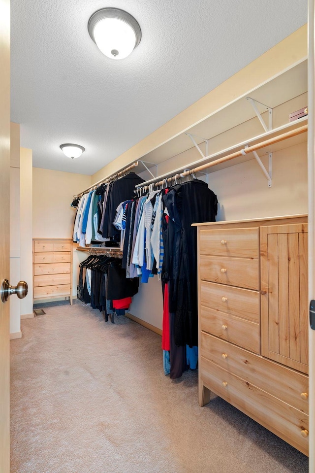 walk in closet featuring carpet floors