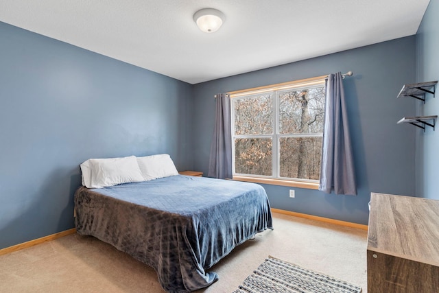 bedroom featuring baseboards and carpet