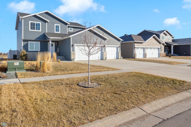 view of front facade with a garage, a residential view, a front yard, and driveway