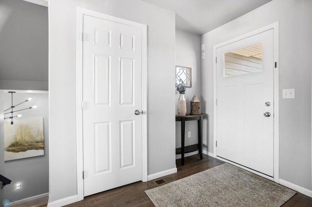 foyer with wood finished floors and baseboards