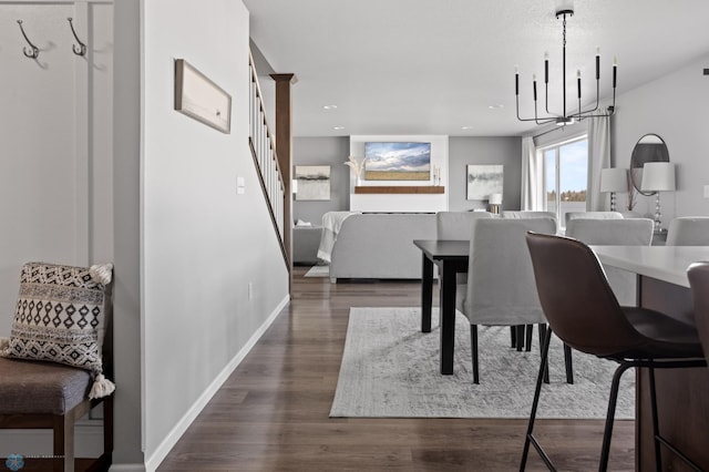 dining room with stairway, baseboards, recessed lighting, dark wood-style flooring, and a notable chandelier