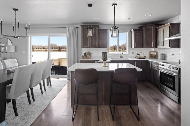 kitchen featuring a sink, dark brown cabinetry, light countertops, stainless steel electric range, and dark wood-style flooring