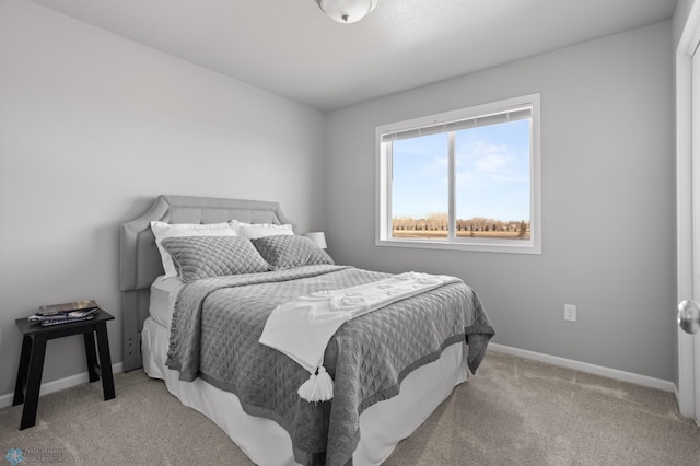 carpeted bedroom featuring baseboards