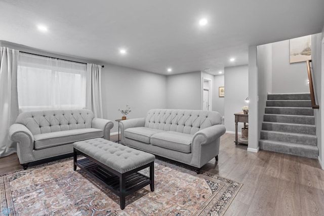 living area with stairs, recessed lighting, wood finished floors, and baseboards