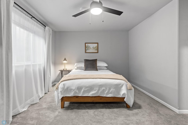 bedroom with baseboards, carpet floors, and ceiling fan