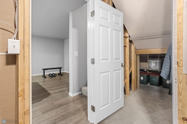 hallway with baseboards and wood finished floors