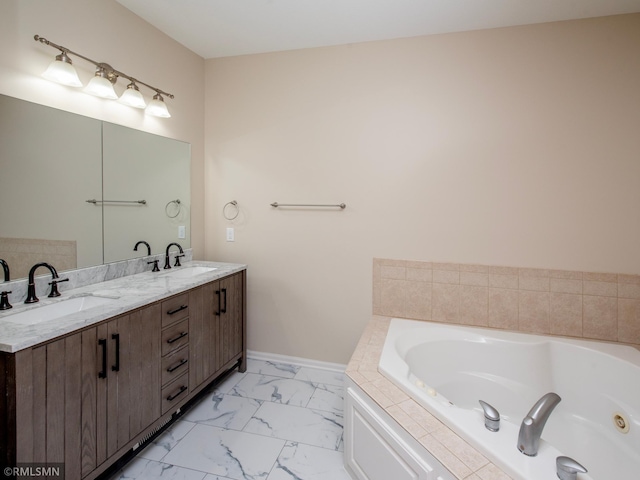 full bathroom featuring double vanity, a tub with jets, marble finish floor, and a sink