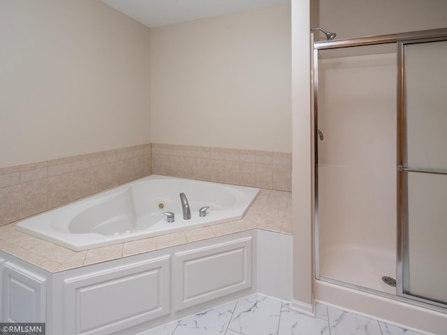 full bathroom with marble finish floor, a jetted tub, and a shower stall