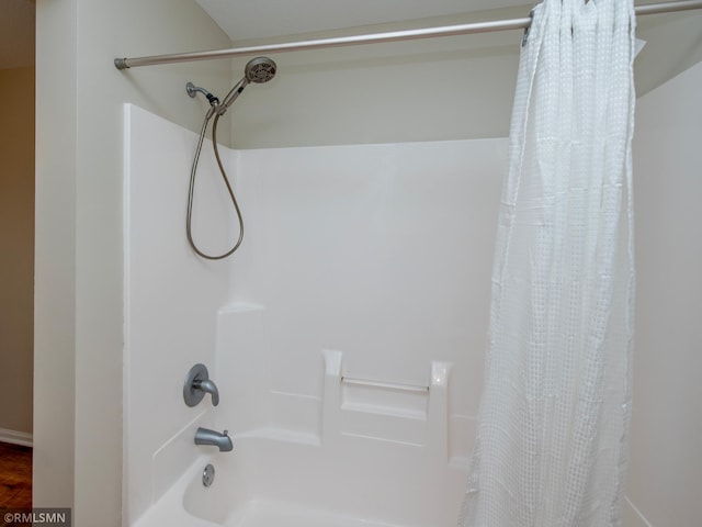 bathroom with shower / bath combo with shower curtain