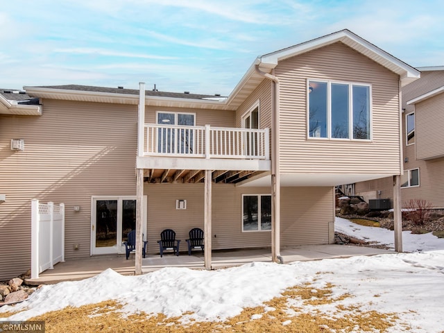 snow covered property featuring a patio and central AC