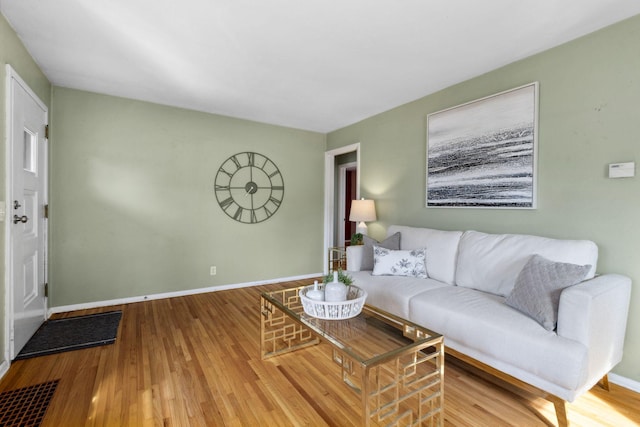 living room featuring baseboards and wood finished floors