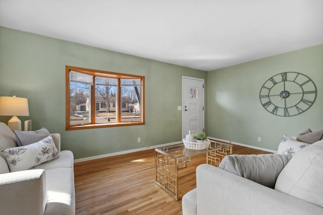 living room with baseboards and wood finished floors