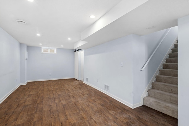 basement with recessed lighting, visible vents, baseboards, and wood finished floors