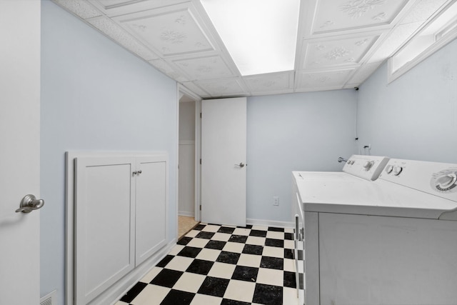 clothes washing area with visible vents, baseboards, laundry area, separate washer and dryer, and dark floors