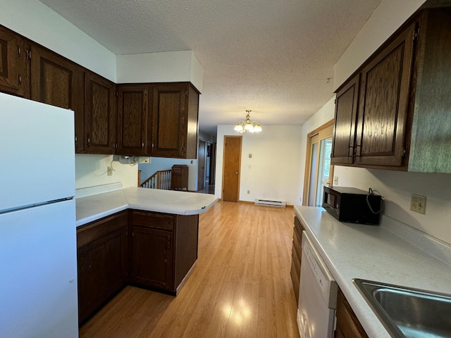 kitchen featuring light wood-style flooring, a baseboard heating unit, white appliances, dark brown cabinetry, and light countertops