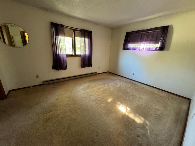 unfurnished room featuring a textured ceiling, a baseboard heating unit, baseboards, and carpet floors