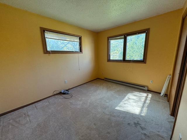 spare room with a textured ceiling, carpet, baseboards, and a baseboard radiator