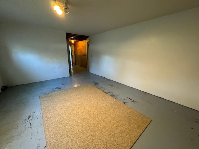 empty room with unfinished concrete flooring