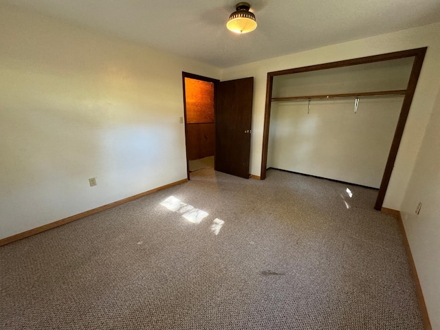 unfurnished bedroom with a closet and baseboards