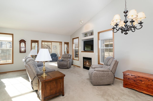 living room featuring carpet flooring, a fireplace, baseboards, and a chandelier