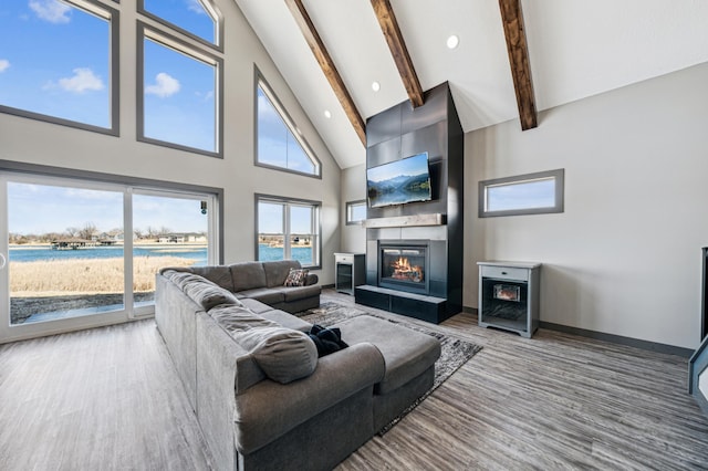 35647 Oxford Ave, Chisago Lake Twp, MN 55012 - living room featuring high vaulted ceiling, beam ceiling, wood finished floors, a large fireplace, and baseboards