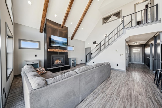 35647 Oxford Ave, Chisago Lake Twp, MN 55012 - living room with high vaulted ceiling, baseboards, stairs, wood finished floors, and beamed ceiling