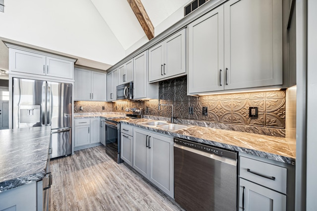 35647 Oxford Ave, Chisago Lake Twp, MN 55012 - kitchen featuring appliances with stainless steel finishes, gray cabinetry, a sink, backsplash, and beamed ceiling