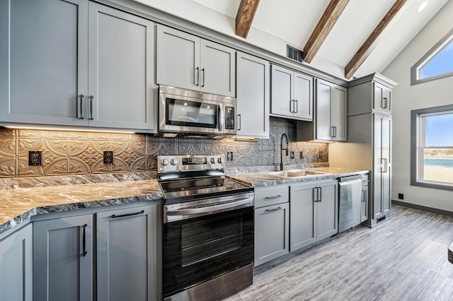35647 Oxford Ave, Chisago Lake Twp, MN 55012 - kitchen featuring stainless steel appliances, gray cabinets, a sink, beam ceiling, and light wood finished floors