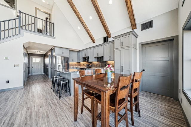 35647 Oxford Ave, Chisago Lake Twp, MN 55012 - dining room featuring wood finished floors, high vaulted ceiling, beamed ceiling, recessed lighting, and baseboards