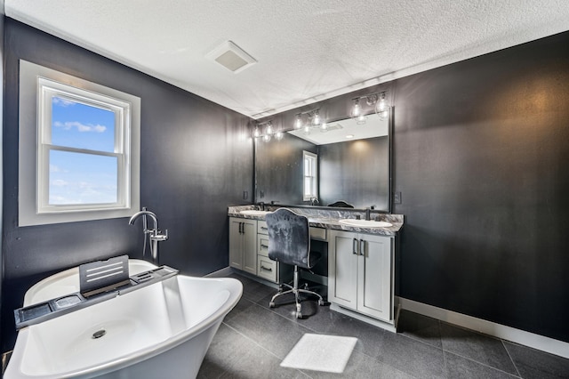35647 Oxford Ave, Chisago Lake Twp, MN 55012 - bathroom featuring double vanity, a freestanding tub, a textured ceiling, and baseboards