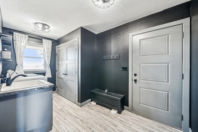 35647 Oxford Ave, Chisago Lake Twp, MN 55012 - mudroom featuring a sink, a textured ceiling, wood finished floors, and baseboards