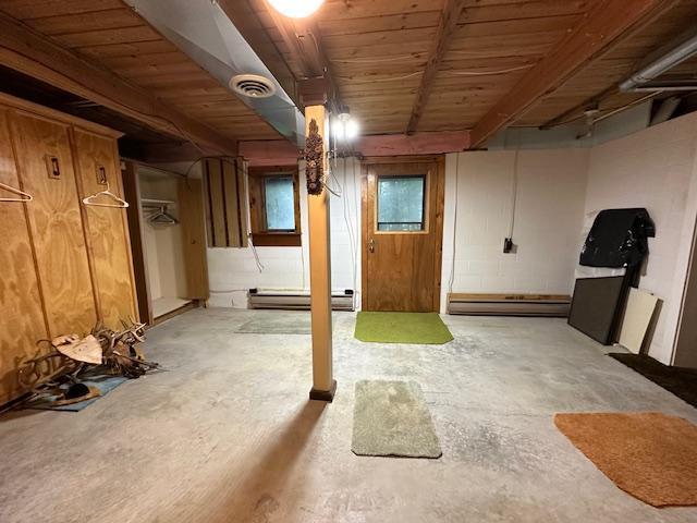 basement with visible vents and baseboard heating