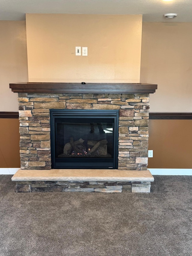 details featuring a fireplace, baseboards, and carpet floors