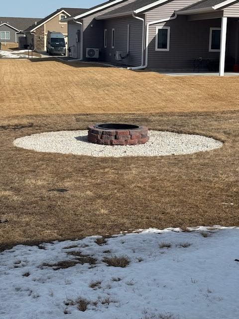 yard covered in snow featuring an outdoor fire pit