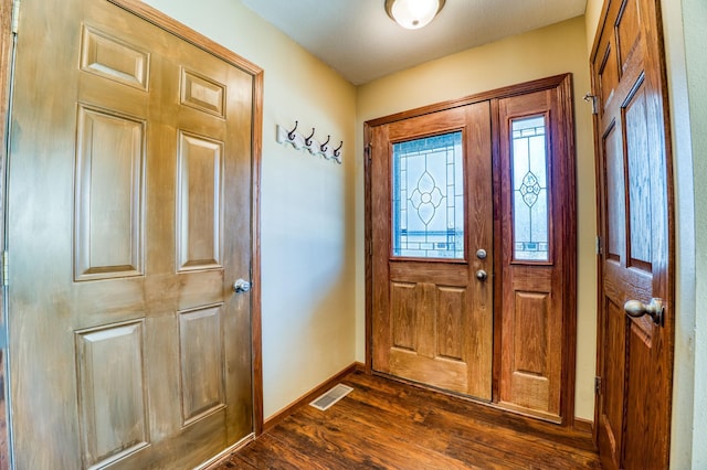 entrance foyer featuring visible vents, baseboards, and dark wood-style flooring