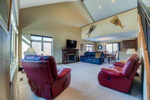 carpeted living room featuring a notable chandelier, a fireplace, visible vents, and high vaulted ceiling