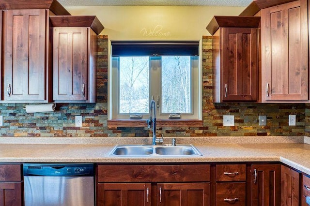 kitchen with dishwasher, light countertops, and a sink