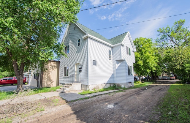 view of property exterior featuring roof with shingles