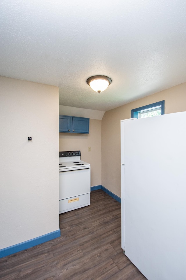 kitchen featuring white appliances, blue cabinets, dark wood-style floors, and baseboards