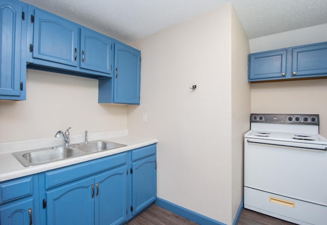 kitchen with white range with electric stovetop, blue cabinetry, and a sink