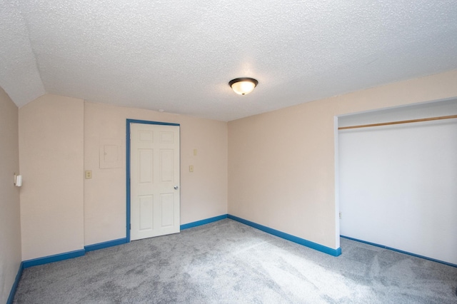 unfurnished bedroom featuring carpet flooring, a closet, and a textured ceiling