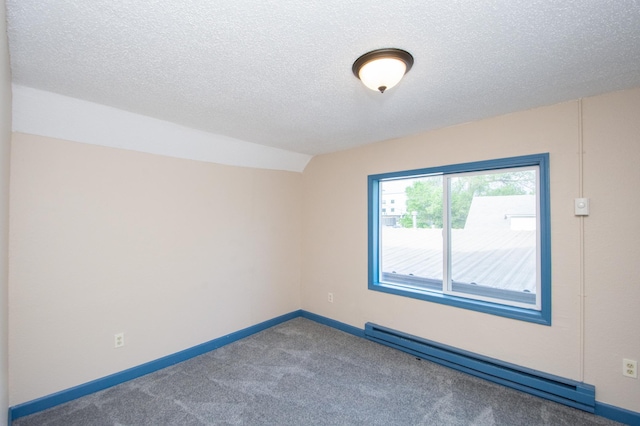 carpeted spare room with a baseboard heating unit, baseboards, a textured ceiling, and vaulted ceiling